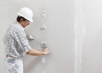 A Painter Doing A Repair On Sheetrock